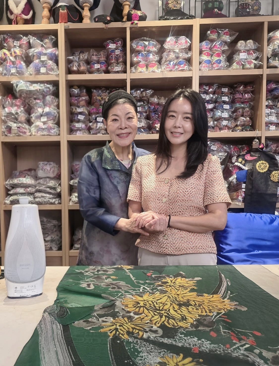 Lee Sang-yi, wife of the late Park Dong-bin, smiles holding hands with ...